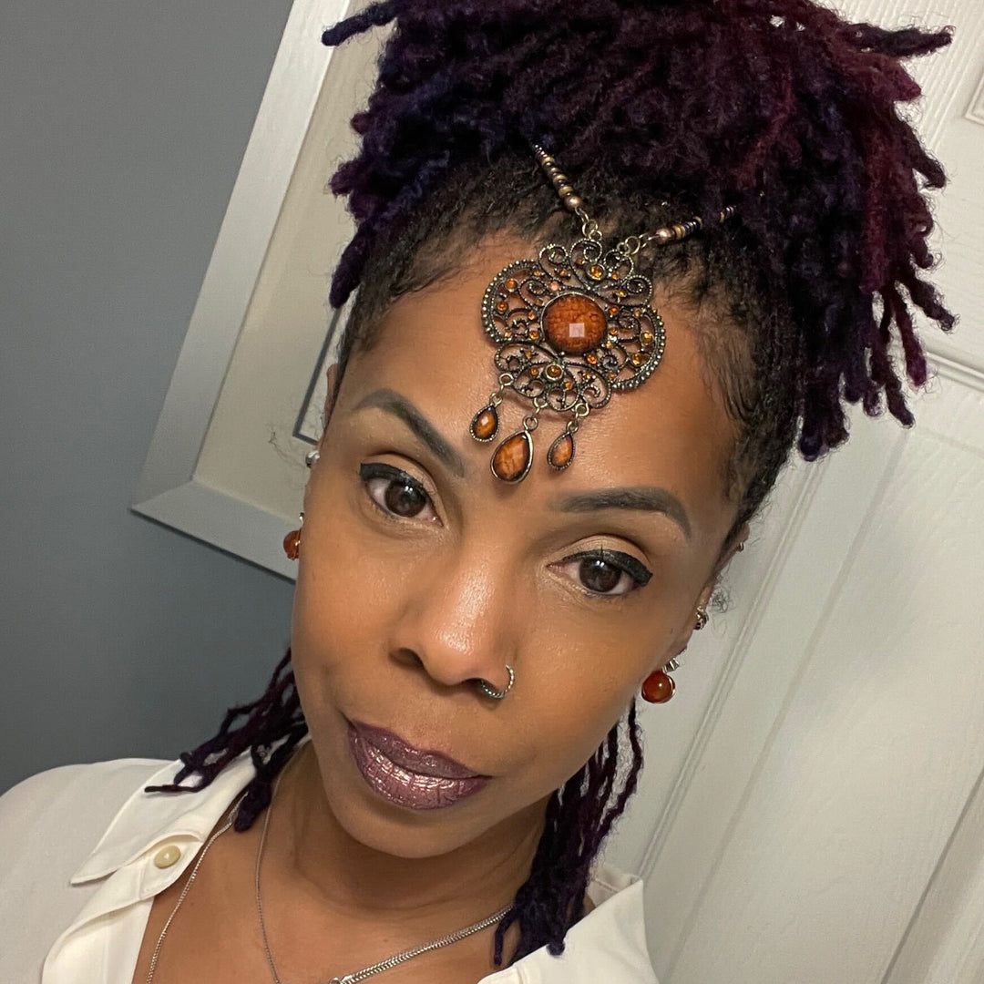 Woman with styled hair and jewelry indoors