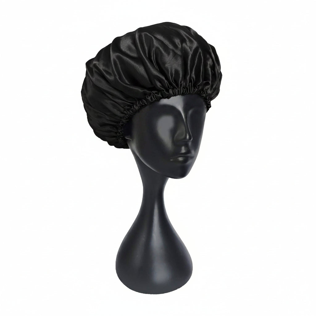 Black satin bonnet on a black mannequin head against a white background